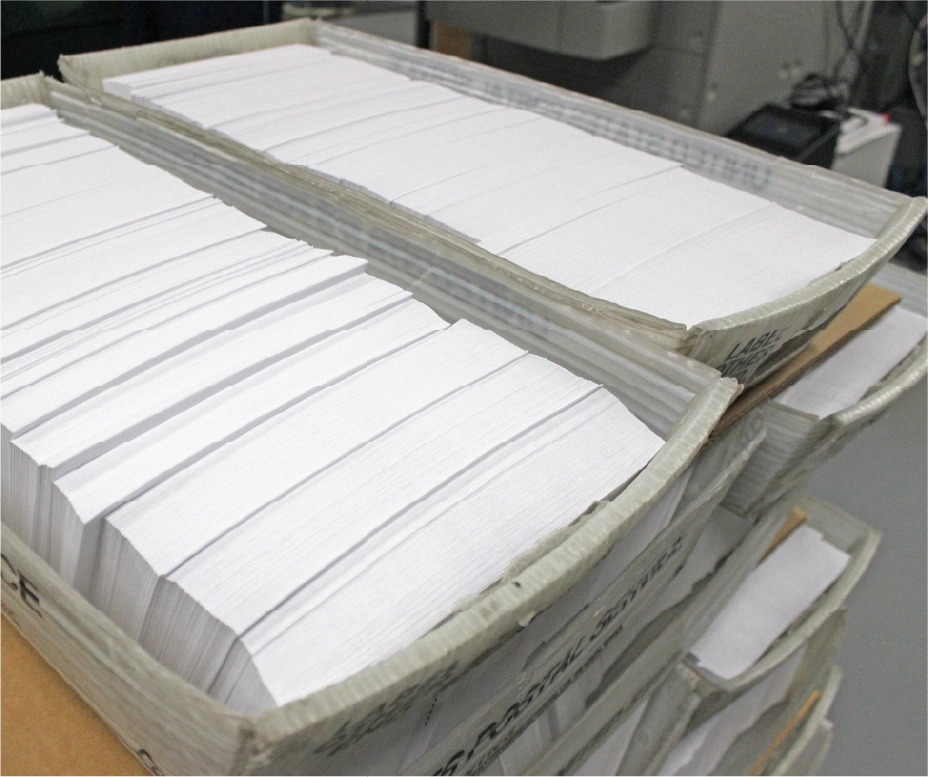 Staff hand-assembling personalized direct mail packages